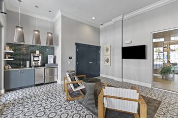 A lounge with a coffee bar and a table and chairs